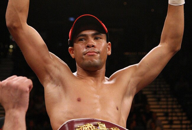 LAS VEGAS - DECEMBER 06:  (L-R) Juan Manuel Lopez of Puerto Rico celebrates his first round knockout of Sergio Medina of Argentina during their WBO junior featherweight title fight at the MGM Grand Garden Arena December 6, 2008 in Las Vegas, Nevada.  (Photo by Jed Jacobsohn/Getty Images)