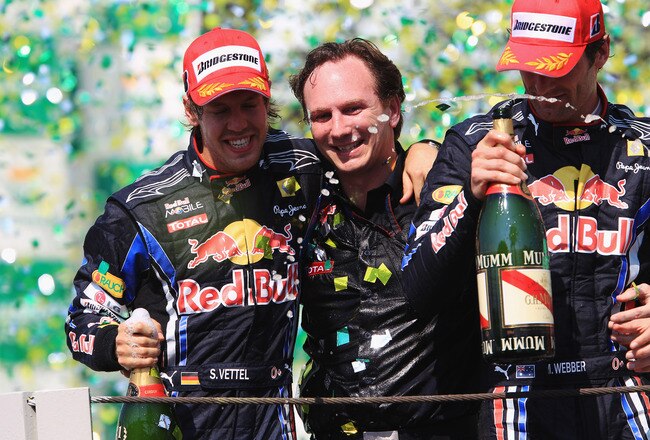 SAO PAULO, BRAZIL - NOVEMBER 07:  (L-R) Race winner Sebastian Vettel of Germany and Red Bull Racing, Red Bull Racing Team Principal Christian Horner and second placed Mark Webber of Australia and Red Bull Racing celebrate on the podium as Vettels win hands Red Bull Racing the Constructors Championship following the Brazilian Formula One Grand Prix at the Interlagos Circuit on November 7, 2010 in Sao Paulo, Brazil.  (Photo by Mark Thompson/Getty Images)