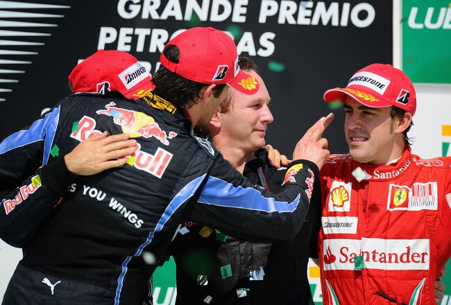 SAO PAULO, BRAZIL - NOVEMBER 07:  (L-R) Second placed Mark Webber of Australia and Red Bull Racing, race winner Sebastian Vettel of Germany and Red Bull Racing, Red Bull Racing Team Principal Christian Horner and third placed Fernando Alonso of Spain and Ferrari celebrate on the podium following the Brazilian Formula One Grand Prix at the Interlagos Circuit on November 7, 2010 in Sao Paulo, Brazil.  (Photo by Clive Mason/Getty Images)