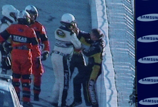 FORT WORTH, TX - NOVEMBER 07:  NASCAR officials break up a fight between Jeff Gordon (2R), driver of the #24 DuPont/National Guard Chevrolet, and Jeff Burton (R), driver of the #31 Caterpillar Chevrolett, as seen on the Sprint Vision screen in the infield after an incident in the NASCAR Sprint Cup Series AAA Texas 500 at Texas Motor Speedway on November 7, 2010 in Fort Worth, Texas.  (Photo by Jonathan Ferrey/Getty Images for NASCAR)