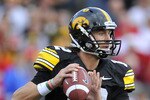 IOWA CITY, IA - OCTOBER 23- Quarterback Ricky Stanzi #12 of the University of Iowa Hawkeyes throws under pressure from the Wisconsin Badgers during the second half of play at Kinnick Stadium on October 23, 2010 in Iowa City, Iowa. Wisconsin won 31-30 over Iowa. (Photo by David Purdy/Getty Images)
