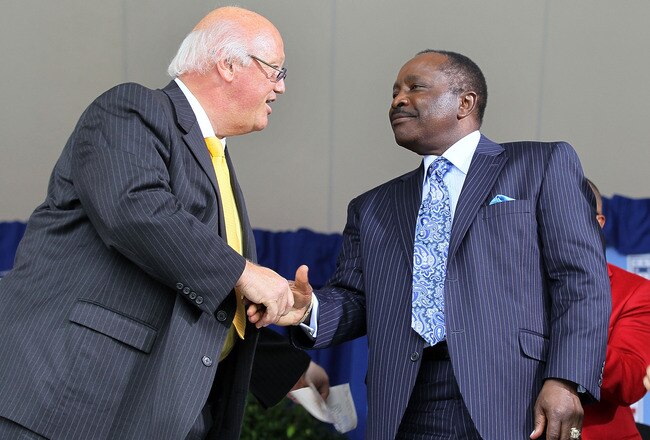 COOPERSTOWN, NY - JULY 25:  Jon Miller (L) shakes hands with Hall of Famer Joe Morgan after Miller received the Ford C. Frick award for contributions in baseball broadcasting at Clark Sports Center during the Baseball Hall of Fame induction ceremony on July 25, 20010 in Cooperstown, New York.  (Photo by Jim McIsaac/Getty Images)