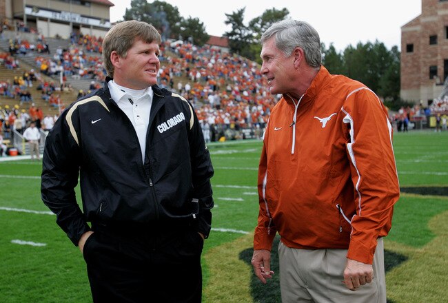 BOULDER, CO - OCTOBER 04:  Head coach Dan Hawkins (L) of the Colorado Buffaloes and head coach Mack Brown (R) of the Texas Longhorns chat as their teams warm up prior to their game at Folsom Field on October 4, 2008 in Boulder, Colorado.  (Photo by Doug Pensinger/Getty Images)