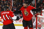 OTTAWA, ON - OCTOBER 14:  Milan Michalek #9 of the Ottawa Senators celebrates a goal with teammate Daniel Alfredsson #11 against Cam Ward #30 of the Carolina Hurricanes during a game at Scotiabank Place on October 14, 2010 in Ottawa, Ontario, Canada.  (Photo by Phillip MacCallum/Getty Images)
