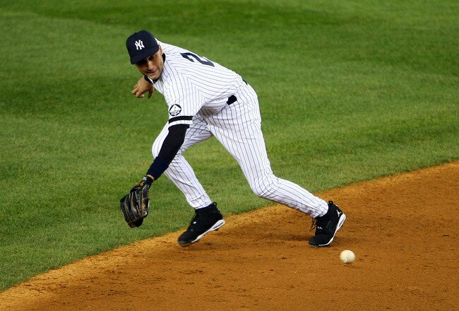 NEW YORK - OCTOBER 18:  Derek Jeter #2 of the New York Yankees fields an infield single hit by Michael Young #10 of the Texas Rangers in the top of the third inning of Game Three of the ALCS during the 2010 MLB Playoffs at Yankee Stadium on October 18, 2010 in New York, New York.  (Photo by Andrew Burton/Getty Images)