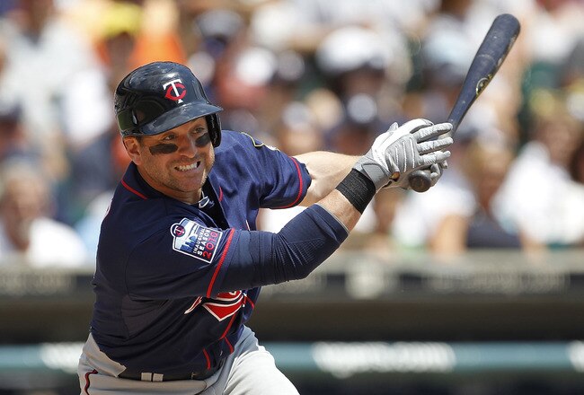 DETROIT - JULY 11:  Nick Punto #8 of the Minnesota Twins singles in the fourth inning during the game against the Detroit Tigers on July 11, 2010 at Comerica Park in Detroit, Michigan. The Twins defeated the Tigers 6-3.  (Photo by Leon Halip/Getty Images)