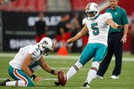 TAMPA, FL - AUGUST 27:  Kicker Dan Carpenter #5 of the Miami Dolphins kicks a field goal out of the hold of Brandon Fields #2 during pregame against the Tampa Bay Buccaneers at Raymond James Stadium on August 27, 2009 in Tampa, Florida.  (Photo by J. Meric/Getty Images)