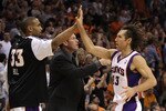 PHOENIX - NOVEMBER 05:  Steve Nash #13 of the Phoenix Suns high fives teammate Grant Hill #33 during the NBA game against the Memphis Grizzlies at US Airways Center on November 5, 2010 in Phoenix, Arizona.  The Suns defeated the Grizzlies 123-118 in double overtime.  NOTE TO USER: User expressly acknowledges and agrees that, by downloading and or using this photograph, User is consenting to the terms and conditions of the Getty Images License Agreement.  (Photo by Christian Petersen/Getty Images)