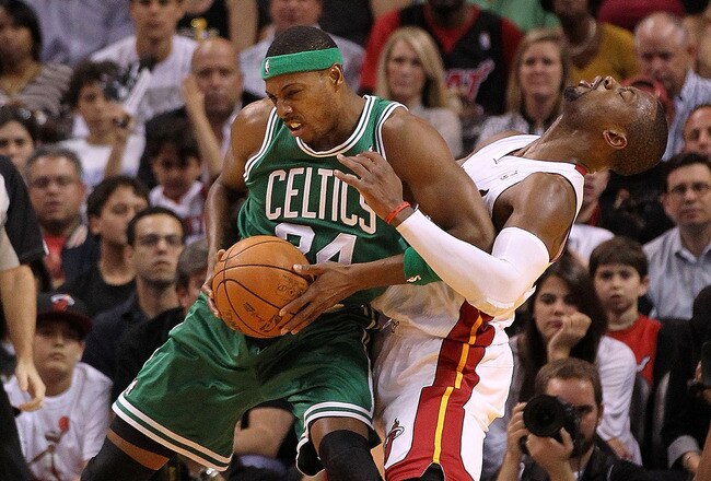 MIAMI - NOVEMBER 11:   Paul Pierce #34 of the Boston Celtics fouls Chris Bosh #1 during a game against the  Miami Heat at American Airlines Arena on November 11, 2010 in Miami, Florida. NOTE TO USER: User expressly acknowledges and agrees that, by downloading and/or using this Photograph, User is consenting to the terms and conditions of the Getty Images License Agreement. (Photo by Mike Ehrmann/Getty Images)