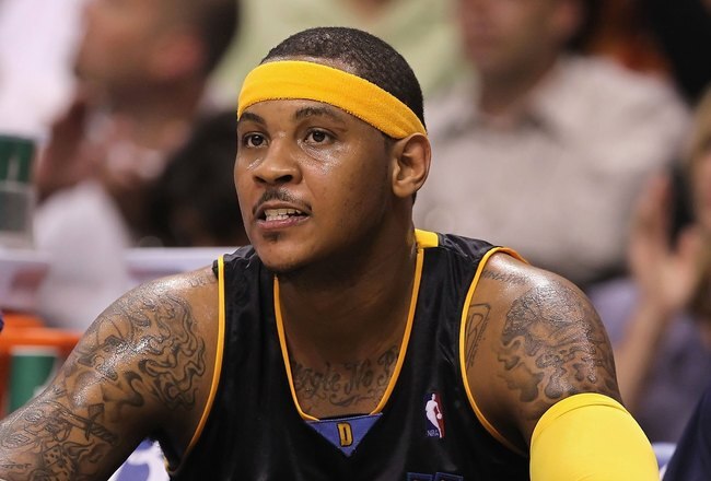PHOENIX - APRIL 13:  Carmelo Anthony #15 of the Denver Nuggets sits on the bench during the NBA game against the Phoenix Suns at US Airways Center on April 13, 2010 in Phoenix, Arizona. The Suns defeated the Nuggets 123-101.  NOTE TO USER: User expressly acknowledges and agrees that, by downloading and or using this photograph, User is consenting to the terms and conditions of the Getty Images License Agreement.  (Photo by Christian Petersen/Getty Images)