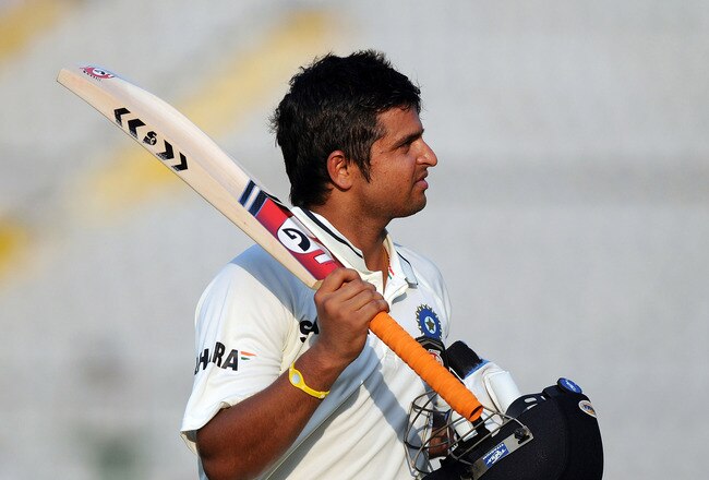 MOHALI, INDIA - OCTOBER 03: Suresh Raina of India  raises his bat to acknowledge the crowd as he walks back to the pavilion after getting out during day three of the First Test match between India and Australia at Punjab Cricket Association Stadium on October 3, 2010 in Mohali, India.  (Photo by Pal Pillai/Getty Images)