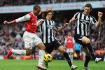 LONDON, ENGLAND - NOVEMBER 07:  Theo Walcott of Arsenal is challenged by Fabricio Coloccini and Mike Williamson of Newcastle during the Barclays Premier League match between Arsenal and Newcastle United at the Emirates Stadium on November 7, 2010 in London, England.  (Photo by Mike Hewitt/Getty Images)