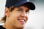ABU DHABI, UNITED ARAB EMIRATES - NOVEMBER 11:  Sebastian Vettel of Germany and Red Bull Racing is interviewed by the media during previews to the Abu Dhabi Formula One Grand Prix at the Yas Marina Circuit on November 11, 2010 in Abu Dhabi, United Arab Emirates.  (Photo by Paul Gilham/Getty Images)