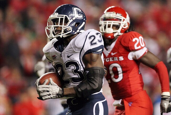 PISCATAWAY, NJ - OCTOBER 08:  Jordan Todman #23 of the Connecticut Huskies runs for a second-quarter touchdown past Khaseem Greene #20 of the Rutgers Scarlet Knights at Rutgers Stadium on October 8, 2010 in Piscataway, New Jersey.  (Photo by Jim McIsaac/Getty Images)