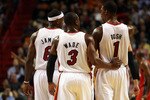 MIAMI - NOVEMBER 06: Dwyane Wade #3, LeBron James #6 and Chris Bosh #1 of the Miami Heat chat during a game against the New Jersey Nets  at American Airlines Arena on November 6, 2010 in Miami, Florida. NOTE TO USER: User expressly acknowledges and agrees that, by downloading and or using this photograph, User is consenting to the terms and conditions of the Getty Images License Agreement.  (Photo by Marc Serota/Getty Images)