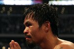 ARLINGTON, TX - MARCH 13:  Manny Pacquiao of the Philippines celebrates in the ring after defeating Joshua Clottey of Ghana during the WBO welterweight title fight at Cowboys Stadium on March 13, 2010 in Arlington, Texas. Pacquiao defeated Clottey by unanimous decision.  (Photo by Jed Jacobsohn/Getty Images)