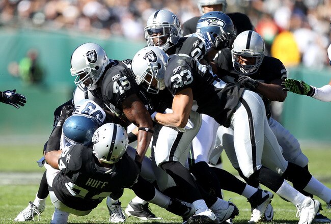 OAKLAND, CA - OCTOBER 31:  The Oakland Raiders defense tackles Leon Washington #33 of the Seattle Seahawks at Oakland-Alameda County Coliseum on October 31, 2010 in Oakland, California.  (Photo by Ezra Shaw/Getty Images)