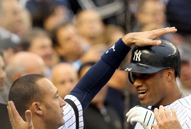 NEW YORK - OCTOBER 20:  Robinson Cano #24 and Derek Jeter #2 (L) of the New York Yankees celebrate in the dugout after Cano hit a solo home run in the third inning against the Texas Rangers in Game Five of the ALCS during the 2010 MLB Playoffs at Yankee Stadium on October 20, 2010 in the Bronx borough of New York City.  (Photo by Jim McIsaac/Getty Images)