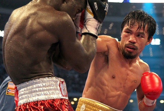 ARLINGTON, TX - MARCH 13:  (R-L) Manny Pacquiao of the Philippines throws a right to the head of Joshua Clottey of Ghana during the WBO welterweight title fight at Cowboys Stadium on March 13, 2010 in Arlington, Texas. Pacquiao defeated Clottey by unanimous decision.  (Photo by Jed Jacobsohn/Getty Images)
