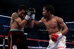ARLINGTON, TX - NOVEMBER 13:  Manny Pacquiao (white trunks) of the Philippines lands a punch against Antonio Margarito (black trunks) of Mexico during their WBC World Super Welterweight Title bout at Cowboys Stadium on November 13, 2010 in Arlington, Texas.  (Photo by Nick Laham/Getty Images)