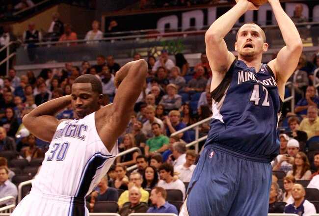 ORLANDO, FL - NOVEMBER 03:  Kevin Love #42 of the Minnesota Timberwolves attempts a shot over Brandon Bass #30 of the Orlando Magic during the game at Amway Arena on November 3, 2010 in Orlando, Florida.  NOTE TO USER: User expressly acknowledges and agrees that, by downloading and or using this Photograph, user is consenting to the terms and conditions of the Getty Images License Agreement.  (Photo by Sam Greenwood/Getty Images)
