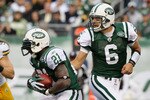 EAST RUTHERFORD, NJ - OCTOBER 31: Mark Sanchez #6 of the New York Jets hands the ball to teammate LaDainian Tomlinson #21 against the Green Bay Packers on October 31, 2010 at the New Meadowlands Stadium in East Rutherford, New Jersey. The Packers defeated the Jets 9-0. (Photo by Jim McIsaac/Getty Images)