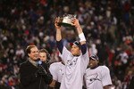 FOXBORO, MA - JANUARY 20:  Tom Brady #12 of the New England Patriots holds up the Lamar Hunt AFC Championship trophy after the Patriots won 21-12 against the San Diego Chargers during the AFC Championship Game on January 20, 2008 at Gillette Stadium in Foxboro, Massachusetts.  (Photo by Chris McGrath/Getty Images)