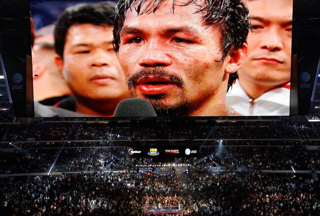 ARLINGTON, TX - NOVEMBER 13:  THe likeness of Manny Pacquiao (white trunks) of the Philippines is seen on the giant screen as he is interviewed after he won against Antonio Margarito (black trunks) of Mexico during their WBC World Super Welterweight Title bout at Cowboys Stadium on November 13, 2010 in Arlington, Texas.  (Photo by Tom Pennington/Getty Images)