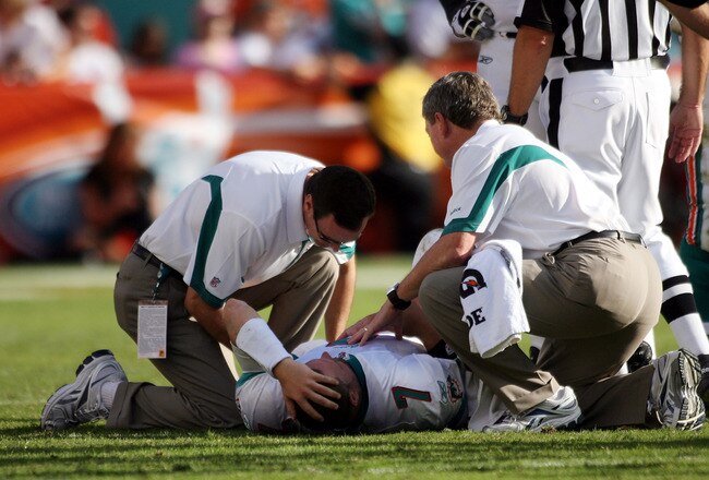 MIAMI - NOVEMBER 14:  Quarterback Chad Henne #7 of the Miami Dolphins is helped on the field  against the Tennessee Titans at Sun Life Stadium on November 14, 2010 in Miami, Florida.  (Photo by Marc Serota/Getty Images)