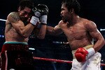 ARLINGTON, TX - NOVEMBER 13:  Manny Pacquiao (white trunks) of the Philippines lands a punch against Antonio Margarito (black trunks) of Mexico during their WBC World Super Welterweight Title bout at Cowboys Stadium on November 13, 2010 in Arlington, Texas.  (Photo by Nick Laham/Getty Images)
