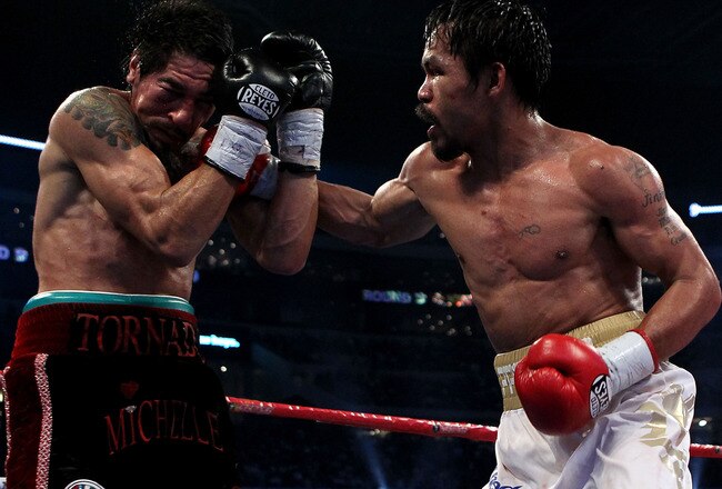 ARLINGTON, TX - NOVEMBER 13:  Manny Pacquiao (white trunks) of the Philippines lands a punch against Antonio Margarito (black trunks) of Mexico during their WBC World Super Welterweight Title bout at Cowboys Stadium on November 13, 2010 in Arlington, Texas.  (Photo by Nick Laham/Getty Images)