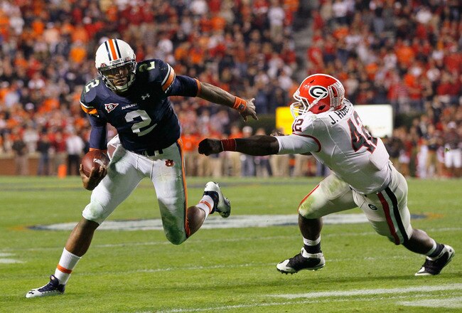 AUBURN, AL - NOVEMBER 13:  Quarterback Cameron Newton #2 of the Auburn Tigers breaks a tackle by Justin Houston #42 of the Georgia Bulldogs at Jordan-Hare Stadium on November 13, 2010 in Auburn, Alabama.  (Photo by Kevin C. Cox/Getty Images)