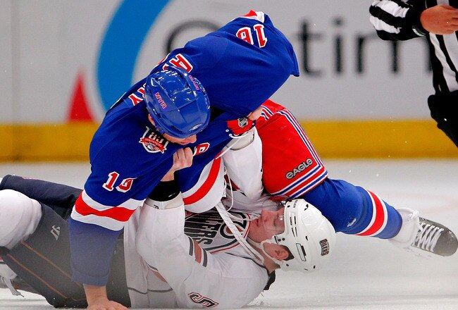 NEW YORK - NOVEMBER 14:  Ladislav Smid #5 of the Edmonton Oilers is throws to the ice by Sean Avery #16 of the New York Rangers after Smid said something to Avery regarding a hard check Avery threw during the third period of a hockey game at Madison Square Garden on November 14, 2010 in New York City.  (Photo by Paul Bereswill/Getty Images)