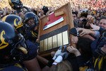 BERKELEY, CA - NOVEMBER 22:  Members of the California Golden Bears run with 'The Axe' after defeating the Stanford Cardinal during an NCAA football game on November 22, 2008 at Memorial Stadium in Berkeley, California.  (Photo by Jed Jacobsohn/Getty Images)