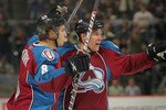 DENVER - NOVEMBER 09:  Kevin Shattenkirk #8 and Jonas Holos #6 of the Colorado Avalanche celebrate a first period goal by teammate Brandon Yip against the Calgary Flames at Pepsi Center on November 9, 2010 in Denver, Colorado.  (Photo by Doug Pensinger/Getty Images)
