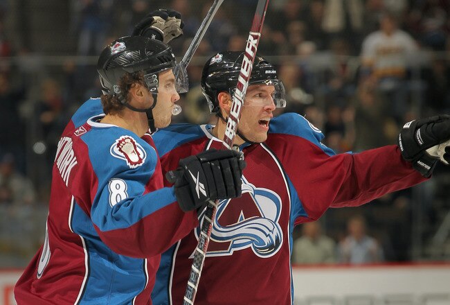 DENVER - NOVEMBER 09:  Kevin Shattenkirk #8 and Jonas Holos #6 of the Colorado Avalanche celebrate a first period goal by teammate Brandon Yip against the Calgary Flames at Pepsi Center on November 9, 2010 in Denver, Colorado.  (Photo by Doug Pensinger/Getty Images)