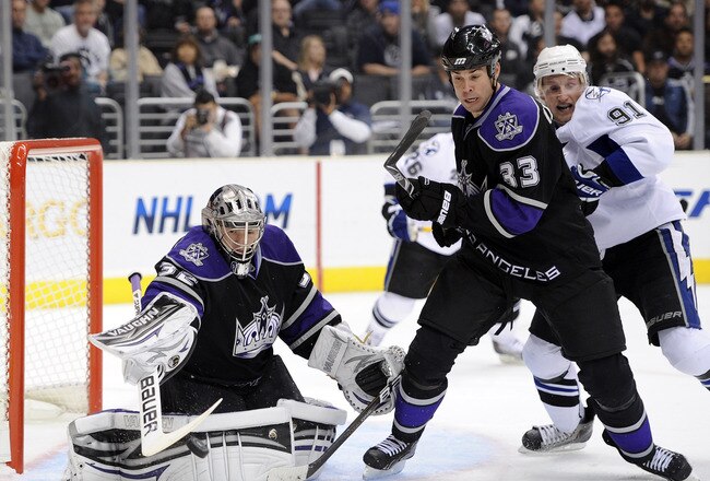 LOS ANGELES, CA - NOVEMBER 04:  Jonathan Quick #32 of the Los Angeles Kings clears a rebound in front of Willie Mitchell #33 and Steven Stamkos #91 of the Tampa Bay Lightning at Staples Center on November 4, 2010 in Los Angeles, California.  (Photo by Harry How/Getty Images)