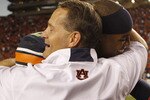 AUBURN - OCTOBER 16:  Head coach Gene Chizik of the Auburn Tigers hugs quarterback Cam Newton #2 after the game against the Arkansas Razorbacks at Jordan-Hare Stadium on October 16, 2010 in Auburn, Alabama.  The Tigers beat the Razorbacks 65-43.  (Photo by Mike Zarrilli/Getty Images)