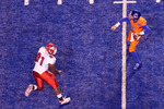 BOISE, ID - NOVEMBER 19:  Kellen Moore #11 of the Boise State Broncos throws a long pass over Anthony Williams #91 of the Fresno State Bulldogs at Bronco Stadium on November 19, 2010 in Boise, Idaho.  (Photo by Otto Kitsinger III/Getty Images)