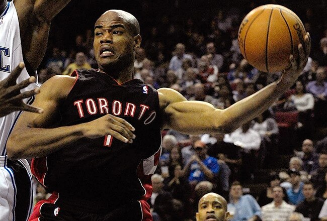 ORLANDO, FL - DECEMBER 16:  Jarrett Jack #1 of the Toronto Raptors looks to pass against Dwight Howard #12 of the Orlando Magic during the game at Amway Arena on December 16, 2009 in Orlando, Florida.  NOTE TO USER: User expressly acknowledges and agrees that, by downloading and/or using this Photograph, user is consenting to the terms and conditions of the Getty Images License Agreement.  (Photo by Sam Greenwood/Getty Images)