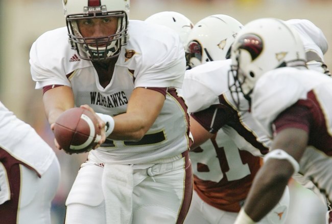 AUSTIN, TX - SEPTEMBER 5:  Quarterback Trey Revell #12 of the Louisiana Monroe Warhawks looks to hand off the ball to a running back during their game against the Texas Longhorns on September 5, 2009 at Darrell K Royal-Texas Memorial Stadium in Austin, Texas. The Longhorns defeated the Warhawks 59-20. (Photo by Brian Bahr/Getty Images)