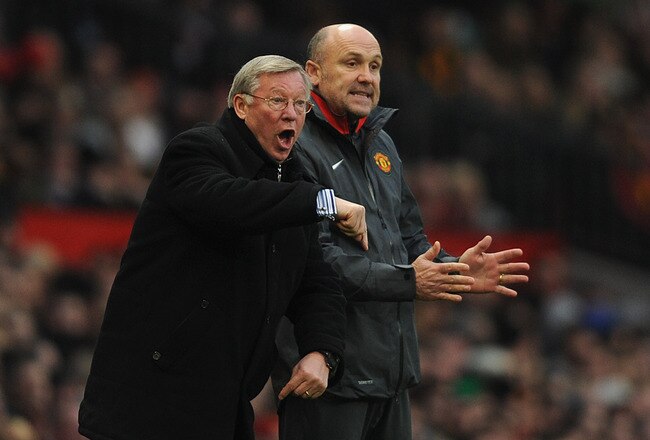 MANCHESTER, ENGLAND - NOVEMBER 20: Manchester United manager Sir Alex Ferguson gestures alongside assistant manager, Mike Phelan during the Barclays Premier League match between Manchester United and Wigan Athletic at Old Trafford on November 20, 2010 in Manchester, England.  (Photo by Michael Regan/Getty Images)