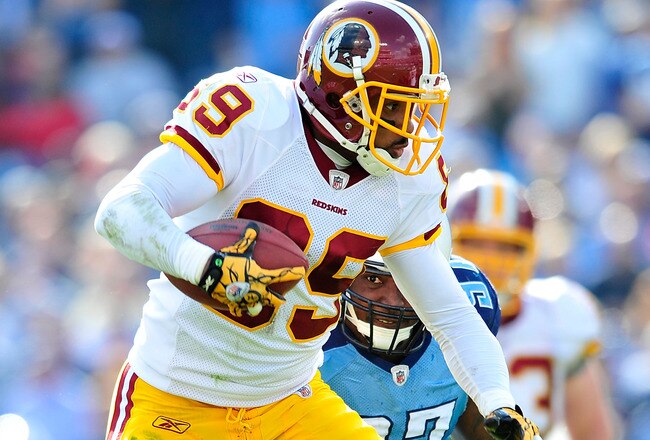 NASHVILLE, TN - NOVEMBER 21:  Santana Moss #89 of the Washington Redskins makes a catch under pressure from Tony Brown #97 of the Tennessee Titans during the first half at LP Field on November 21, 2010 in Nashville, Tennessee.  (Photo by Grant Halverson/Getty Images)