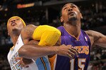 DENVER - NOVEMBER 11:  Ron Artest #15 of the Los Angeles Lakers battles for position with Carmelo Anthony #15 of the Denver Nuggets at the Pepsi Center on November 11, 2010 in Denver, Colorado. The Nuggets defeated the Lakers 118-112.  NOTE TO USER: User expressly acknowledges and agrees that, by downloading and/or using this Photograph, User is consenting to the terms and conditions of the Getty Images License Agreement.  (Photo by Doug Pensinger/Getty Images)