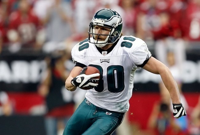 GLENDALE, AZ - JANUARY 18:  Wide receiver Kevin Curtis #80 of the Philadelphia Eagles runs after making a catch as he runs by safety Adrian Wilson #24 of the Arizona Cardinals during the NFC championship game on January 18, 2009 at University of Phoenix Stadium in Glendale, Arizona.  (Photo by Jamie Squire/Getty Images)