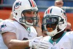 MIAMI - NOVEMBER 14:  Running Back Ronnie Brown #23 of the Miami Dolphins celebrates a touchdown with teammate Anthony Fasano #80 against the Tennessee Titans at Sun Life Stadium on November 14, 2010 in Miami, Florida.  (Photo by Marc Serota/Getty Images)