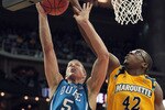 KANSAS CITY, MO - NOVEMBER 22:  Chris Otule #42 of the Marquette Golden Eagles blocks a shot by Mason Plumlee #5 of the Duke Blue Devils during the CBE Classic game on November 22, 2010 at the Sprint Center in Kansas City, Missouri.  (Photo by Jamie Squire/Getty Images)