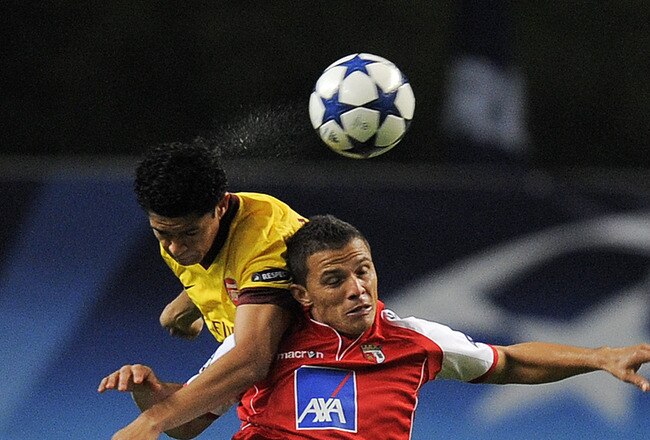 BRAGA, PORTUGAL - NOVEMBER 23: Denilson of Arsenal (L) and Lima of SC Braga duel for a high ball during the UEFA Champions League Group H match between SC Braga and Arsenal at Estadio Municipal de Braga on November 23, 2010 in Braga, Portugal.  (Photo by David Ramos/Getty Images)