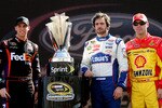 HOMESTEAD, FL - NOVEMBER 21:  (L-R) Denny Hamlin, driver of the #11 FedEx Toyota, stands next to the Sprint Cup trophy with Jimmie Johnson, driver of the #48 Lowe's Chevrolet, and Kevin Harvick, driver of the #29 Shell/Pennzoil Chevrolet, during the NASCAR Sprint Cup Series Ford 400 at Homestead-Miami Speedway on November 21, 2010 in Homestead, Florida.  (Photo by Jerry Markland/Getty Images for NASCAR)
