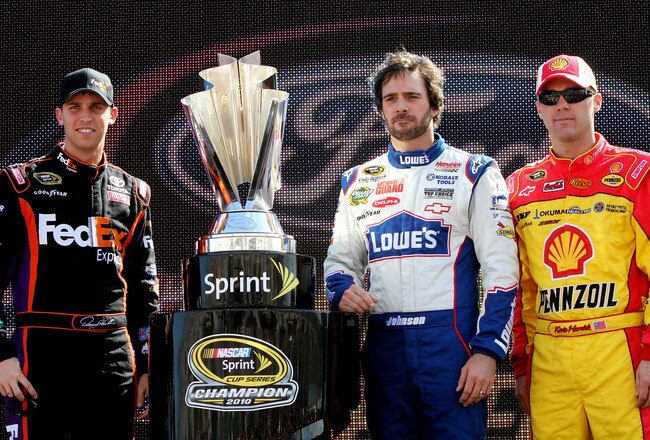 HOMESTEAD, FL - NOVEMBER 21:  (L-R) Denny Hamlin, driver of the #11 FedEx Toyota, stands next to the Sprint Cup trophy with Jimmie Johnson, driver of the #48 Lowe's Chevrolet, and Kevin Harvick, driver of the #29 Shell/Pennzoil Chevrolet, during the NASCAR Sprint Cup Series Ford 400 at Homestead-Miami Speedway on November 21, 2010 in Homestead, Florida.  (Photo by Jerry Markland/Getty Images for NASCAR)